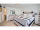 Calm bedroom featuring a wood-frame bed, dresser, and neutral decor at 28 Seaside Ct, Holmes Beach, FL 34217