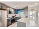 Modern kitchen with gray cabinetry, white subway tile backsplash, and stainless steel appliances at 28 Seaside Ct, Holmes Beach, FL 34217