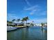 Waterfront homes with private boat docks and lifts under a clear blue sky at 28 Seaside Ct, Holmes Beach, FL 34217