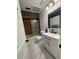Bathroom features updated vanity, framed mirror, and shower/tub combo at 3104 Apricot St, Seffner, FL 33584