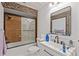 Bathroom features a shower-over-tub, decorative stone, and a modern sink and vanity at 3104 Apricot St, Seffner, FL 33584