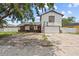 Two-story home with a white exterior, brown trim, and a front yard with a basketball hoop at 3104 Apricot St, Seffner, FL 33584