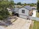 Exterior view of property featuring large driveway, garage, fenced yard, and basketball hoop at 3104 Apricot St, Seffner, FL 33584