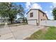 Side view of a two-story home with white exterior, brown trim, and long driveway with basketball hoop at 3104 Apricot St, Seffner, FL 33584