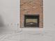 Living room with a brick fireplace and modern white tiled floors at 3104 Apricot St, Seffner, FL 33584