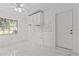 Bright room with a ceiling fan, white cabinets, and a window at 3104 Apricot St, Seffner, FL 33584