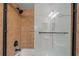 Close-up of the tile shower with a frosted glass door and black hardware at 3104 Apricot St, Seffner, FL 33584