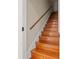 Inviting staircase featuring hardwood steps, natural light, and a stained wood handrail at 3104 Apricot St, Seffner, FL 33584