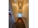 View down wooden stairs with yellow walls and light fixture at 3104 Apricot St, Seffner, FL 33584