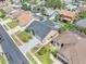 An aerial view of the house showcasing the roof, driveway, and beautifully landscaped front yard at 332 Wood Dove Ave, Tarpon Springs, FL 34689