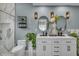 Modern bathroom with double vanity, marble tile shower with glass door, and sleek fixtures at 332 Wood Dove Ave, Tarpon Springs, FL 34689