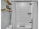 Well-lit bathroom with white tiled shower and tub, complemented by a shower curtain and dark hardware at 332 Wood Dove Ave, Tarpon Springs, FL 34689