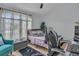 Bright bedroom with large window, a workspace, and comfortable seating, perfect for relaxation and productivity at 332 Wood Dove Ave, Tarpon Springs, FL 34689