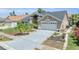 Well-maintained single-Gathering home with a two-car garage, lush landscaping, and a freshly painted driveway at 332 Wood Dove Ave, Tarpon Springs, FL 34689