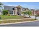 A beautiful single-Gathering home with a well-kept lawn, mature trees, and a welcoming entrance at 332 Wood Dove Ave, Tarpon Springs, FL 34689
