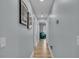Bright hallway with wood floors, light blue walls, and decorative artwork at 332 Wood Dove Ave, Tarpon Springs, FL 34689