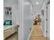 Inviting hallway leading to a bedroom and living area with wood floors and access to a variety of living spaces at 332 Wood Dove Ave, Tarpon Springs, FL 34689