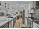 Modern kitchen with a center island, stainless steel appliances, and elegant finishes at 332 Wood Dove Ave, Tarpon Springs, FL 34689