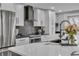 Bright kitchen with white cabinets, stainless steel appliances, and an island with a marble countertop at 332 Wood Dove Ave, Tarpon Springs, FL 34689