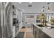 Contemporary kitchen with stainless steel appliances, white cabinets, and a large island with a sink at 332 Wood Dove Ave, Tarpon Springs, FL 34689