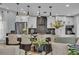 Open-concept kitchen with white cabinets, dark countertops, and an island with seating at 332 Wood Dove Ave, Tarpon Springs, FL 34689