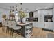 Modern kitchen with an island, stylish pendant lighting, and stainless steel appliances at 332 Wood Dove Ave, Tarpon Springs, FL 34689