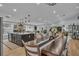 Expansive living area showcasing a modern kitchen, dining space, and comfortable seating, perfect for entertaining at 332 Wood Dove Ave, Tarpon Springs, FL 34689