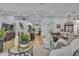 Open-concept living room with neutral tones, modern furniture, and plenty of natural light at 332 Wood Dove Ave, Tarpon Springs, FL 34689