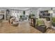 Inviting living room with neutral furniture, hardwood floors, and large windows offering ample light at 332 Wood Dove Ave, Tarpon Springs, FL 34689