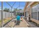 Enjoy outdoor dining on the screened patio with a pool view, including a grill for summer BBQs at 332 Wood Dove Ave, Tarpon Springs, FL 34689