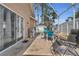 Covered patio area featuring outdoor seating and barbecue grill, perfect for entertaining guests at 332 Wood Dove Ave, Tarpon Springs, FL 34689