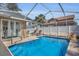 Beautiful screened-in pool area with patio seating, perfect for outdoor relaxation and entertaining at 332 Wood Dove Ave, Tarpon Springs, FL 34689