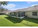Spacious backyard featuring a large screened-in patio at 35229 Janine Dr, Zephyrhills, FL 33541