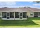 View of the spacious screened-in patios and green backyard at 35229 Janine Dr, Zephyrhills, FL 33541