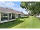 Lush backyard featuring a screened-in patio with views of the pond at 35229 Janine Dr, Zephyrhills, FL 33541