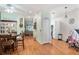 Spacious hallway with wood-look floors connecting the dining area, kitchen, and living spaces at 35229 Janine Dr, Zephyrhills, FL 33541