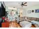 Comfortable living room features a plush sectional sofa, wood flooring, and tasteful decor at 35229 Janine Dr, Zephyrhills, FL 33541