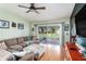 A cozy living room with a comfortable sectional sofa and access to the outdoor patio area at 35229 Janine Dr, Zephyrhills, FL 33541