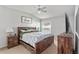 Inviting main bedroom with a vaulted ceiling, a window, and a comfortable wood frame bed at 35229 Janine Dr, Zephyrhills, FL 33541