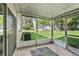 Enclosed patio with screened windows offers views of the large, well-manicured backyard at 35229 Janine Dr, Zephyrhills, FL 33541