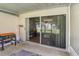 Covered patio featuring tile flooring, outdoor cooking equipment, and sliding glass doors at 35229 Janine Dr, Zephyrhills, FL 33541