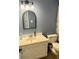 Bathroom featuring a white vanity and an arched mirror at 3615 Pine Knot Dr, Valrico, FL 33596