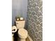Powder room featuring a classic white toilet and eye-catching navy and white wallpaper at 3615 Pine Knot Dr, Valrico, FL 33596