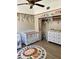 Well-appointed Bedroom featuring a crib, dresser with changing table, and themed rug at 3615 Pine Knot Dr, Valrico, FL 33596