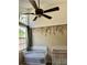 Cozy Bedroom featuring two cribs, a large window, and floral wallpaper accent at 3615 Pine Knot Dr, Valrico, FL 33596