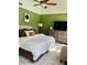 Well-lit bedroom featuring a ceiling fan, vaulted ceiling, and modern décor at 3615 Pine Knot Dr, Valrico, FL 33596