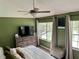 Cozy bedroom featuring waterfront view, TV, ceiling fan, and soft natural light at 3615 Pine Knot Dr, Valrico, FL 33596