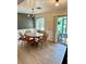 Cozy dining area with a wooden table set, stylish light fixture, and sliding glass doors at 3615 Pine Knot Dr, Valrico, FL 33596