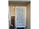Inviting front entrance with security door, welcome sign, and flower pot at 3615 Pine Knot Dr, Valrico, FL 33596