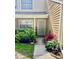 Inviting home entrance with a well-kept walkway, lush landscaping, and secure storm door at 3615 Pine Knot Dr, Valrico, FL 33596